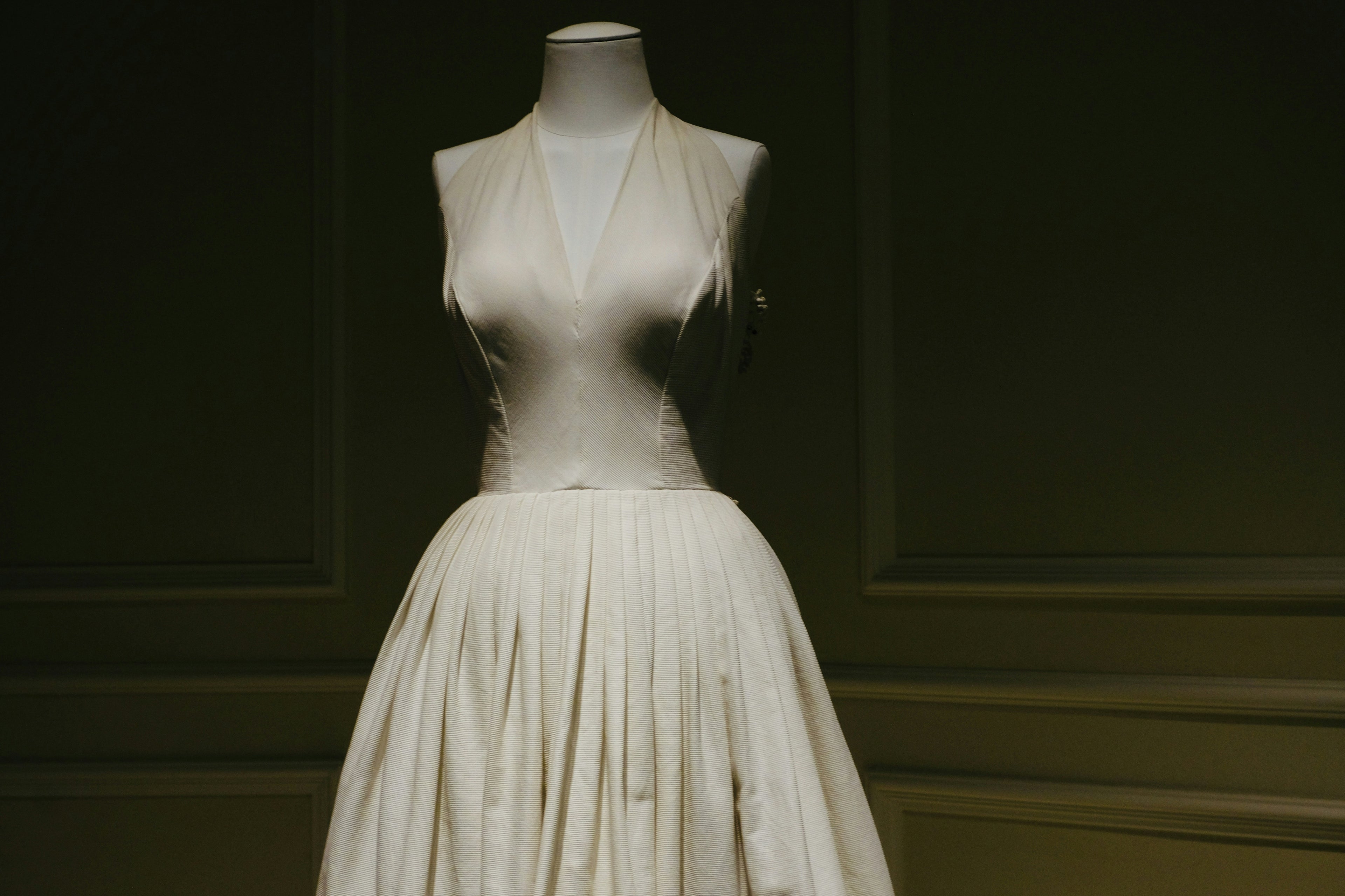 White dress on a mannequin against a dark background